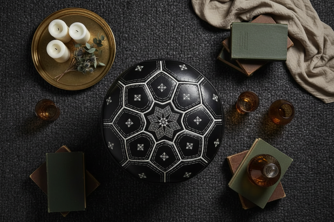 Moroccan artisan hand-stamping intricate geometric patterns onto a genuine leather pouf in a traditional Marrakech workshop